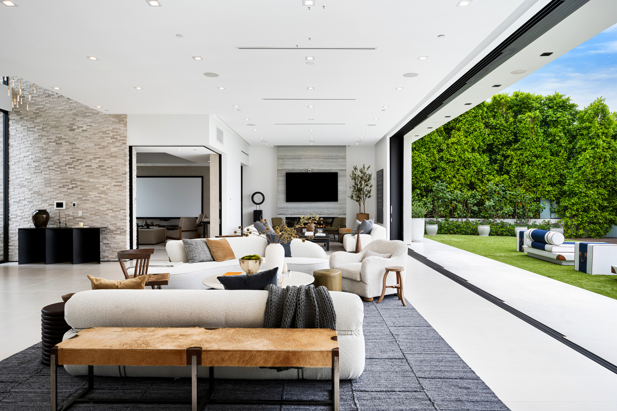 A Spacious living room with elegant chairs and white couches